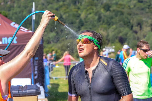 Triathlete cooling down with a hose 